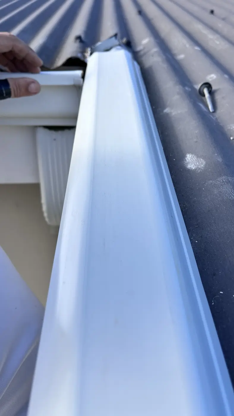 Close view of aluminium roofline component during installation