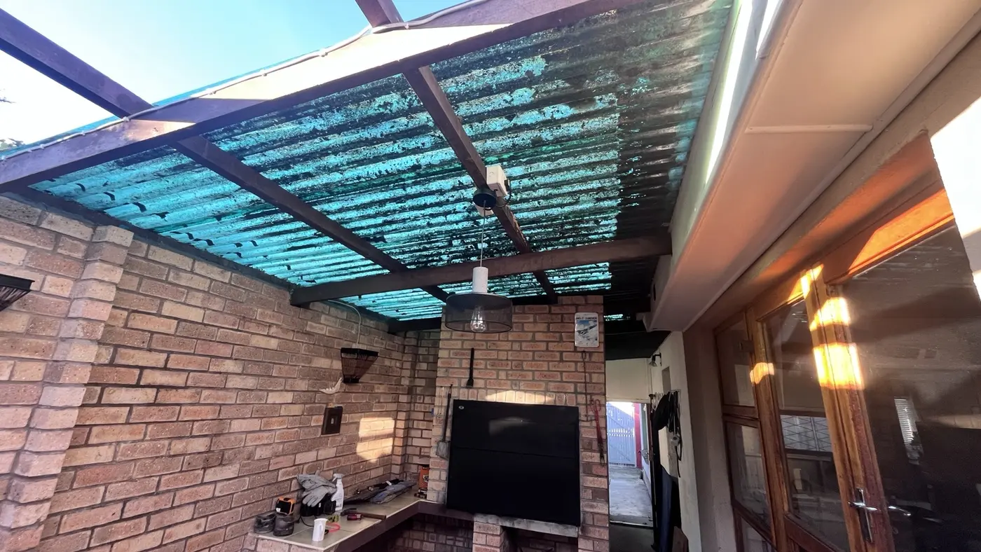 Patio with aged roof sheeting before renovation